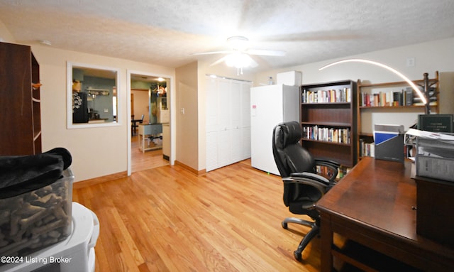 office area with ceiling fan, a textured ceiling, and light wood-type flooring