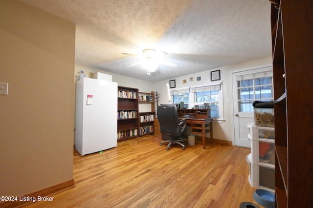 office area featuring ceiling fan, a textured ceiling, and light hardwood / wood-style flooring