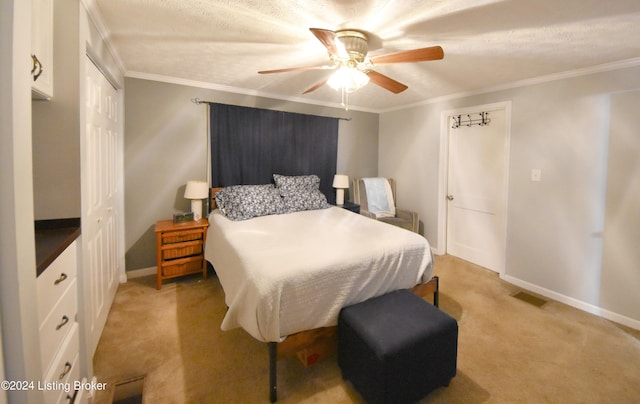 bedroom with light carpet, a closet, ornamental molding, and ceiling fan