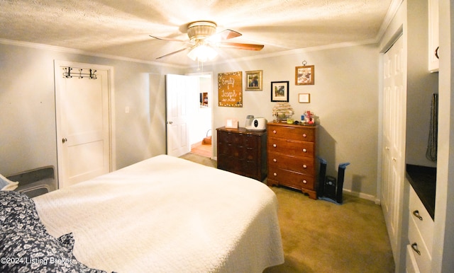 carpeted bedroom featuring ornamental molding, a textured ceiling, and ceiling fan