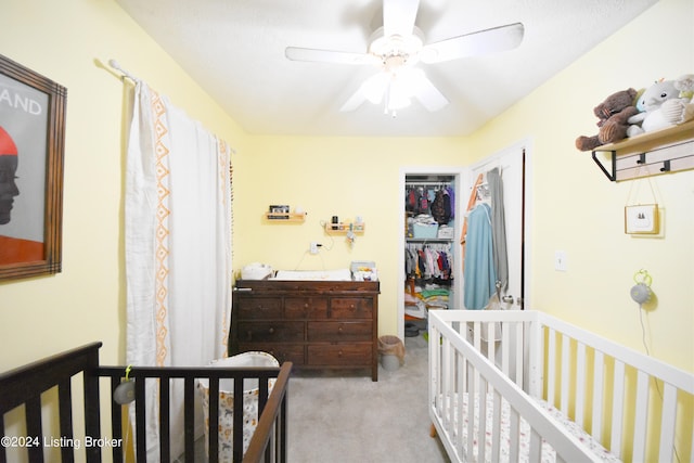 carpeted bedroom with a closet and ceiling fan