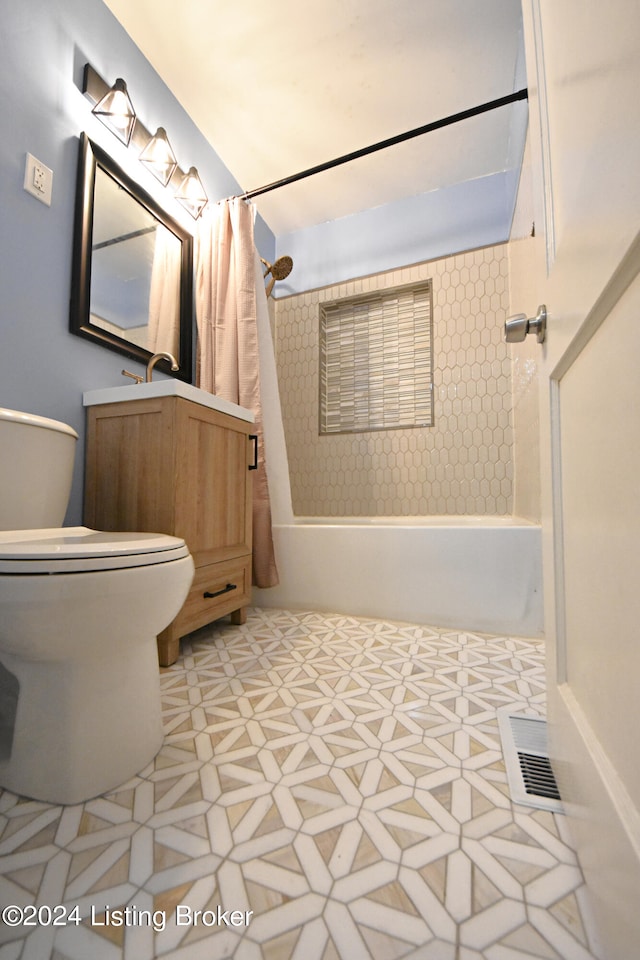 bathroom with tile patterned floors, shower / bath combo with shower curtain, and toilet