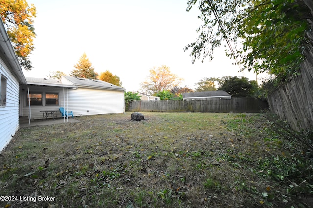 view of yard with a patio and an outdoor fire pit