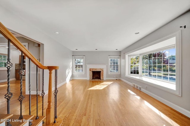 unfurnished living room with light hardwood / wood-style flooring and a fireplace