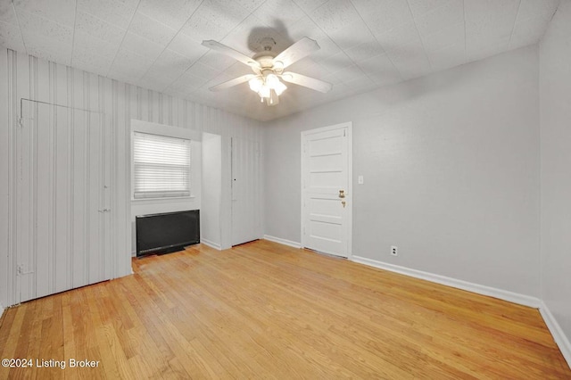 spare room featuring ceiling fan and light wood-type flooring