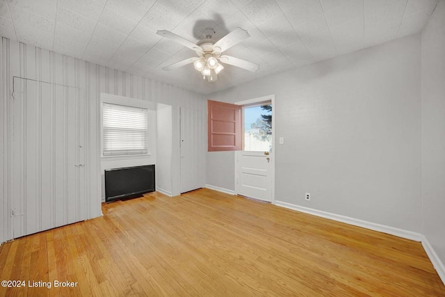 spare room featuring light hardwood / wood-style flooring and ceiling fan