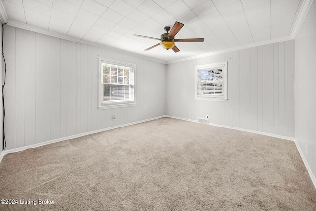 unfurnished room featuring ornamental molding, carpet, and ceiling fan