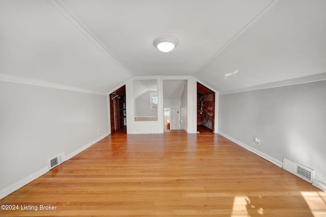 bonus room with vaulted ceiling and light hardwood / wood-style flooring