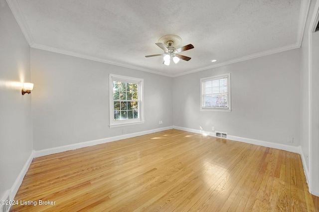 spare room with ornamental molding, light hardwood / wood-style flooring, a textured ceiling, and ceiling fan