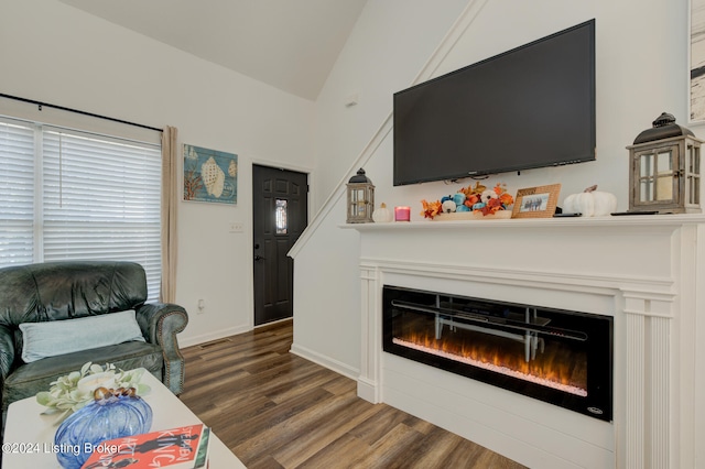 living room featuring lofted ceiling and dark hardwood / wood-style flooring