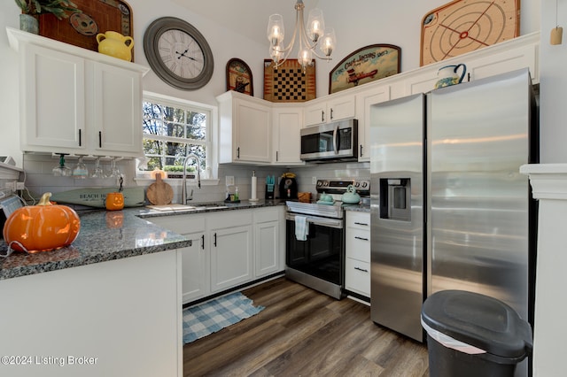 kitchen with white cabinets, tasteful backsplash, stainless steel appliances, and dark wood-type flooring