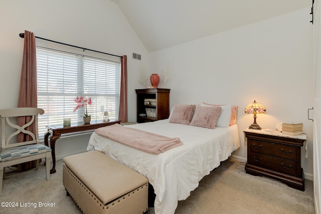 bedroom with light carpet and lofted ceiling