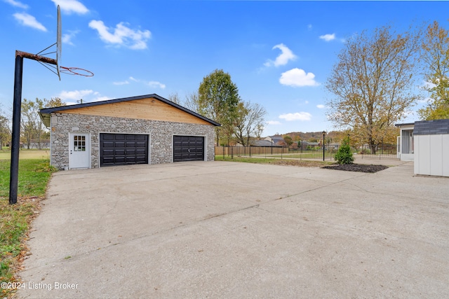 exterior space with an outbuilding and a garage