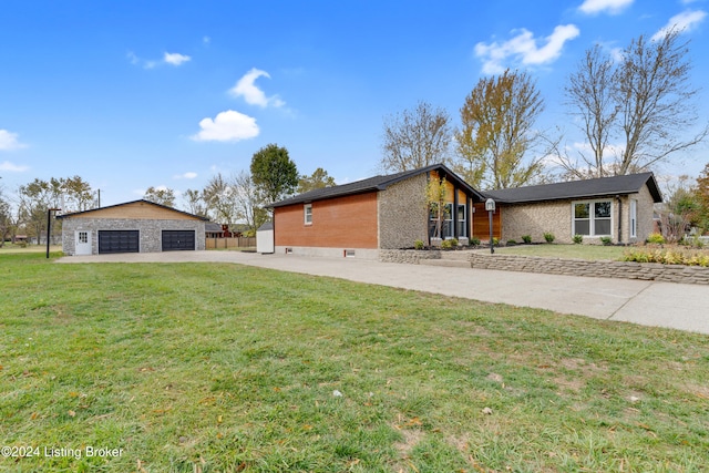 view of side of property featuring a garage and a yard