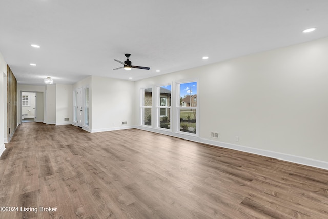 unfurnished living room featuring light hardwood / wood-style flooring and ceiling fan