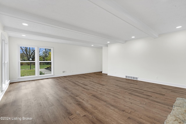 unfurnished room with dark wood-type flooring and beamed ceiling