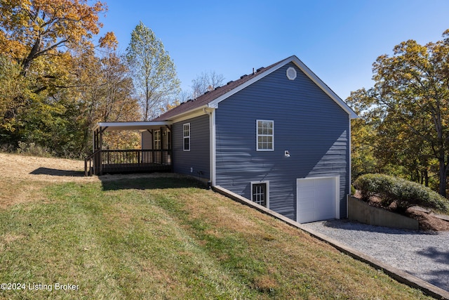 view of home's exterior featuring a lawn and a garage