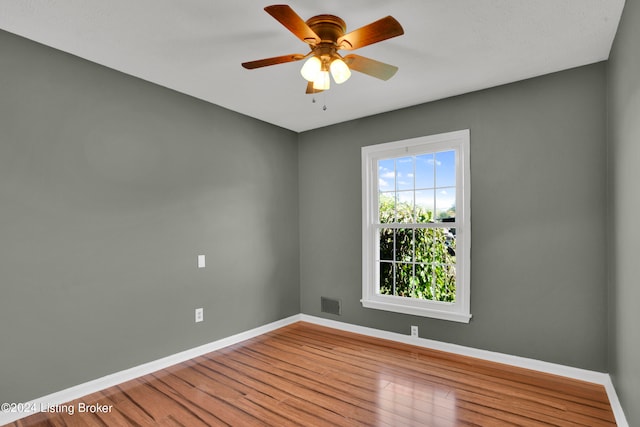 spare room with ceiling fan and wood-type flooring