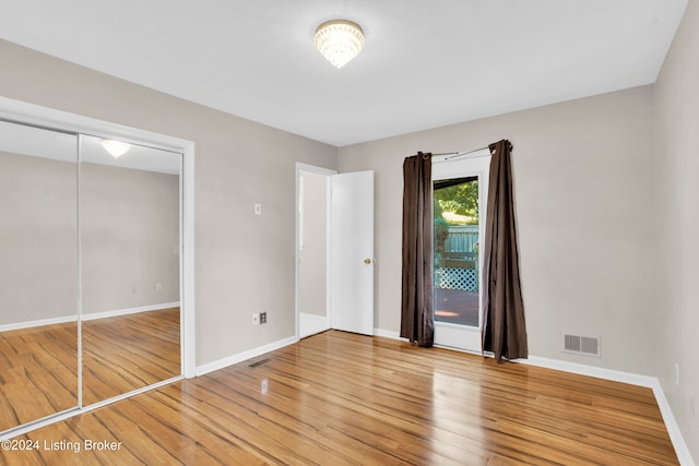 unfurnished bedroom featuring a closet and wood-type flooring