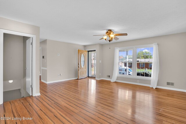 unfurnished living room with light hardwood / wood-style flooring and ceiling fan