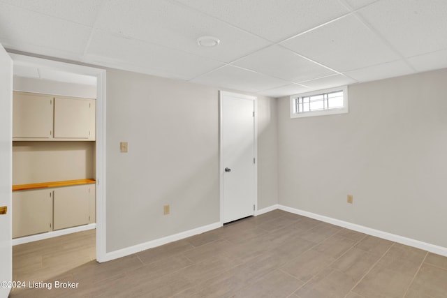 basement with a paneled ceiling