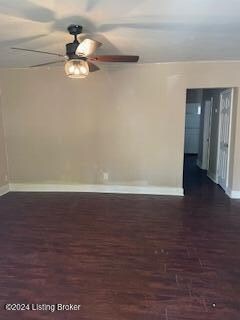 empty room with dark wood-type flooring and ceiling fan