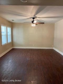 spare room with dark wood-type flooring and ceiling fan