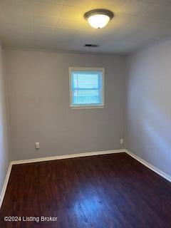 empty room with dark hardwood / wood-style floors