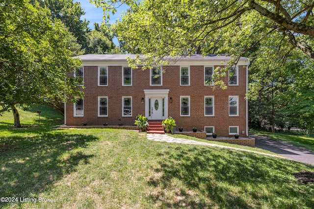 colonial inspired home with a front yard