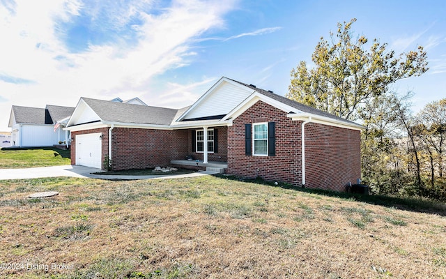 ranch-style home with a garage and a front lawn