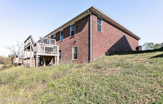 rear view of house featuring a deck