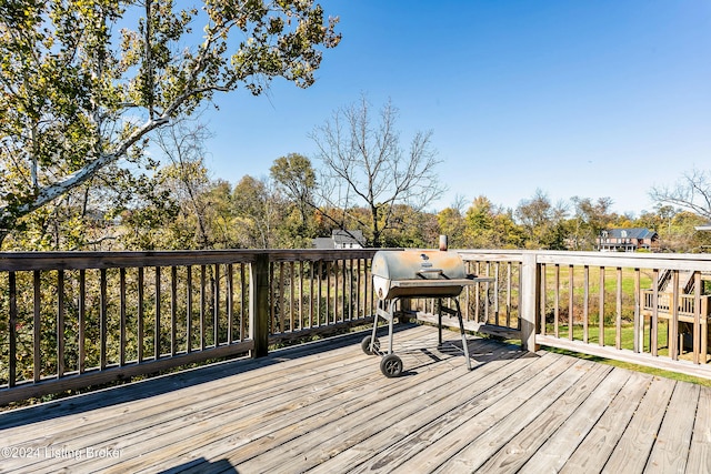 wooden deck with a grill