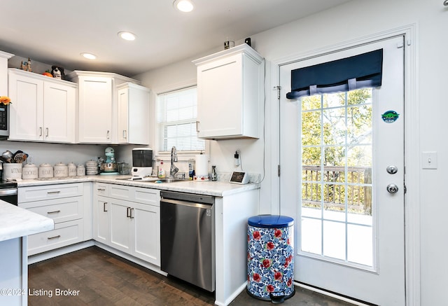 kitchen featuring sink, appliances with stainless steel finishes, white cabinetry, and dark hardwood / wood-style flooring