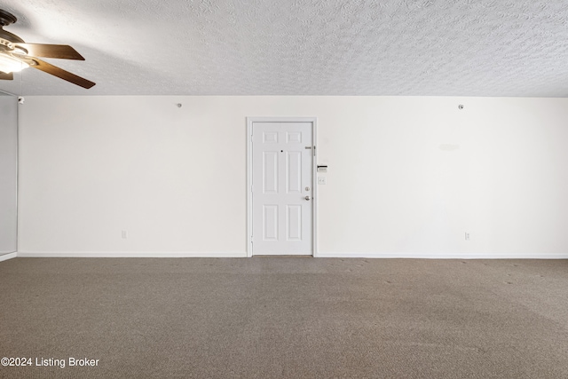 empty room with a textured ceiling and ceiling fan