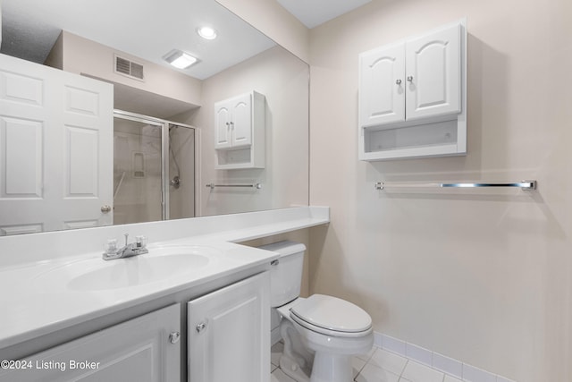 bathroom featuring vanity, walk in shower, toilet, and tile patterned floors