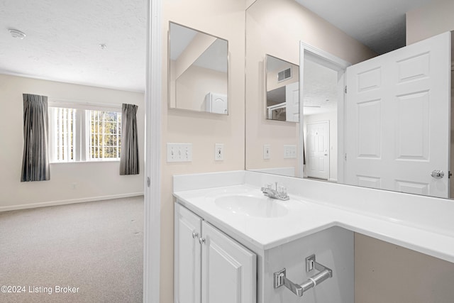 bathroom featuring vanity and a textured ceiling