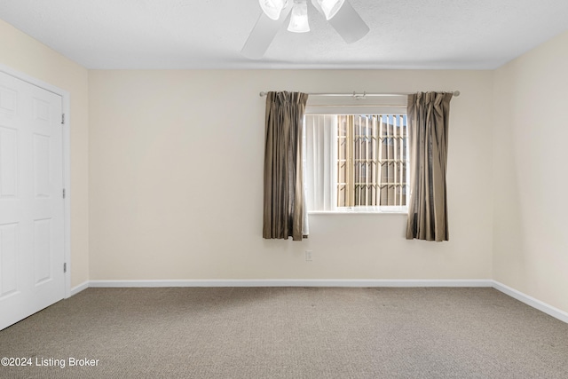 carpeted empty room with ceiling fan