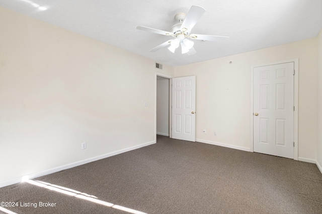 spare room featuring carpet floors and ceiling fan