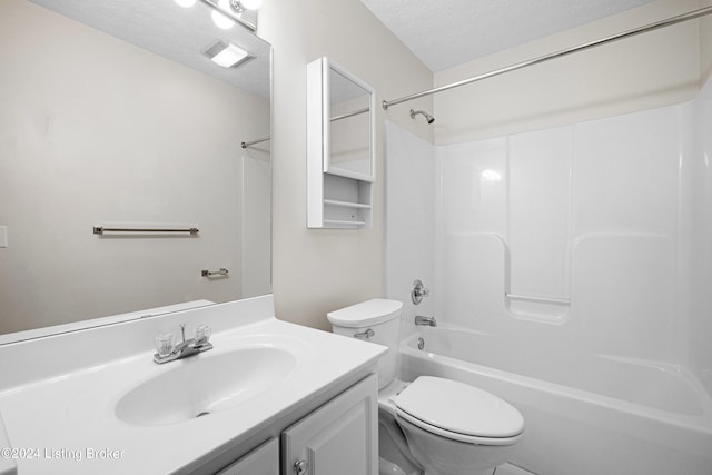 full bathroom with vanity, toilet, a textured ceiling, and  shower combination