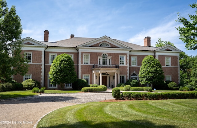 greek revival inspired property with a front yard