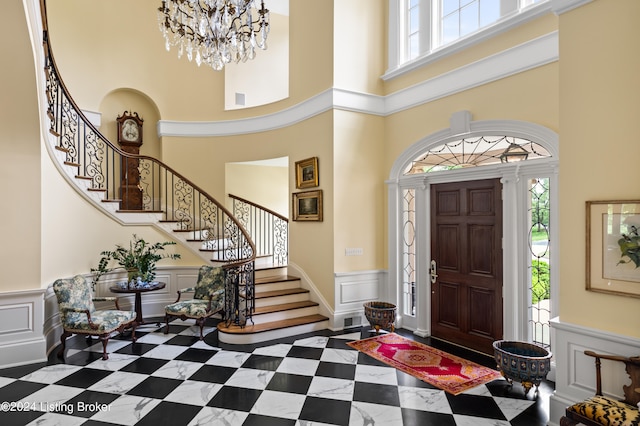 foyer entrance featuring a towering ceiling