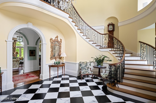 entrance foyer featuring a towering ceiling and dark hardwood / wood-style flooring