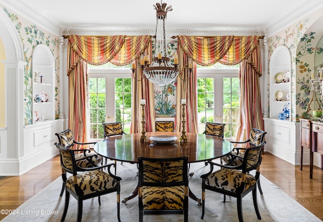 dining space with ornamental molding, french doors, wood-type flooring, and plenty of natural light