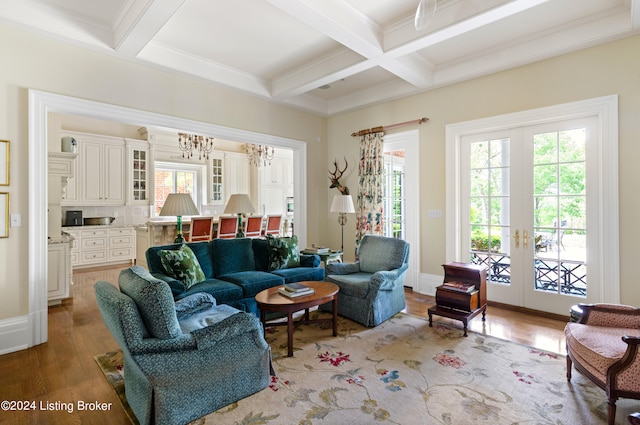 living area with french doors, hardwood / wood-style flooring, and a healthy amount of sunlight