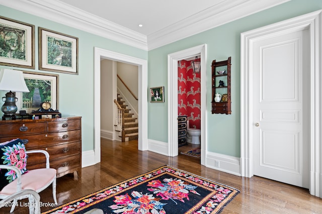 sitting room featuring crown molding and hardwood / wood-style flooring