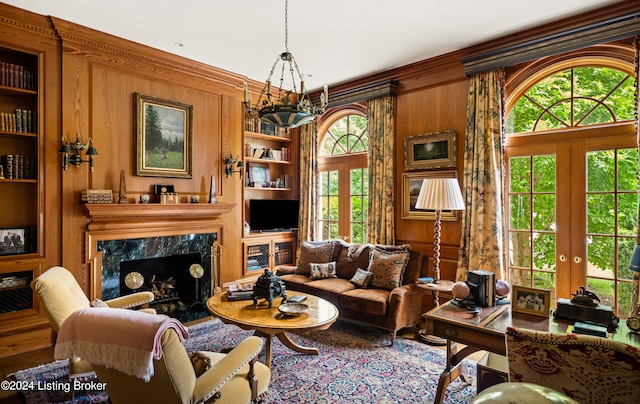 sitting room featuring plenty of natural light, french doors, and built in features