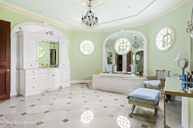 bathroom with vanity, a notable chandelier, ornamental molding, and a washtub