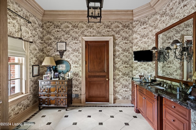 bathroom featuring ornamental molding and sink