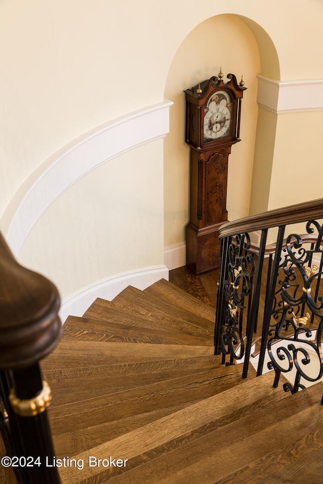 stairs featuring hardwood / wood-style floors