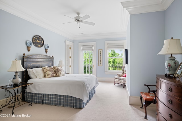 bedroom featuring ornamental molding, light colored carpet, and ceiling fan